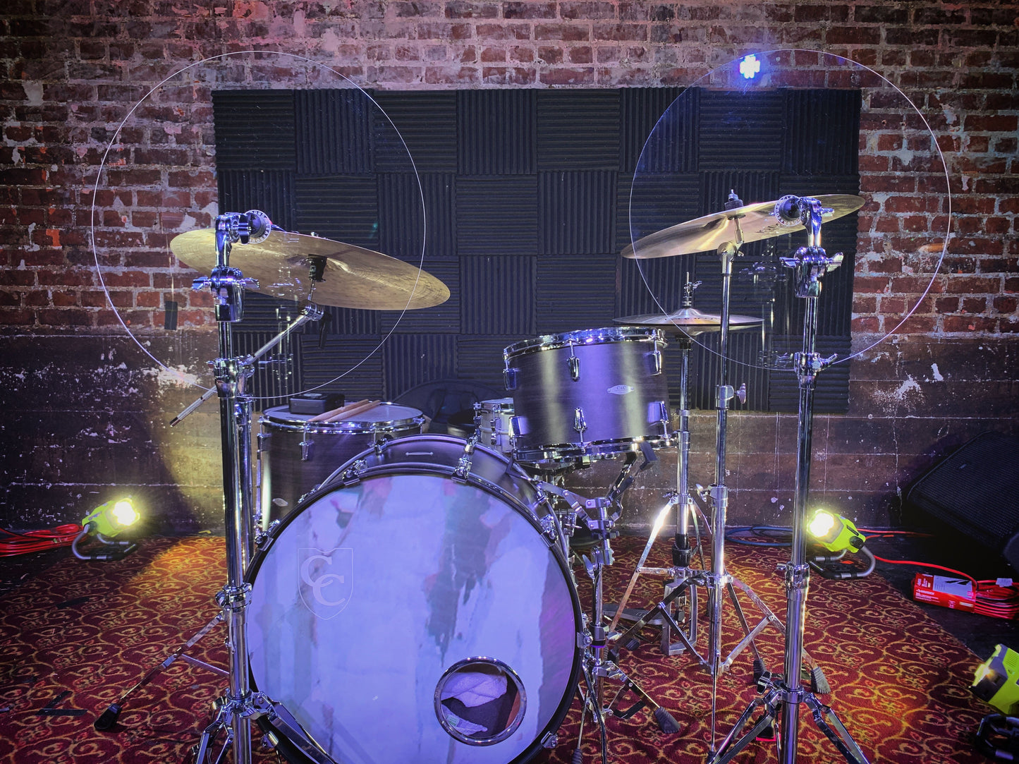 Two cymbal baffles on drum set in front of cymbals