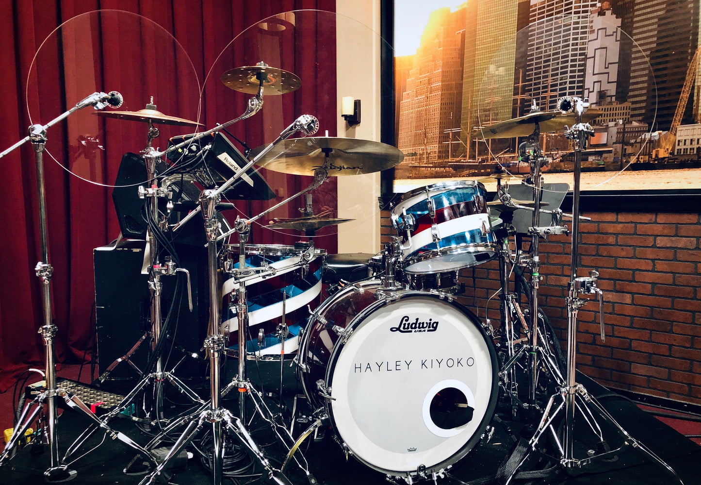 Drum set with clear cymbal baffles and drum shield