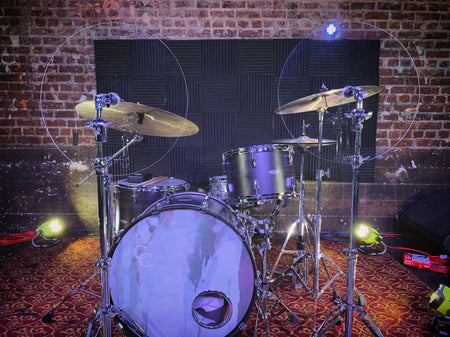 Two cymbal baffles on drum set in front of cymbals