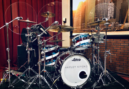 Drum set with clear cymbal baffles and drum shield