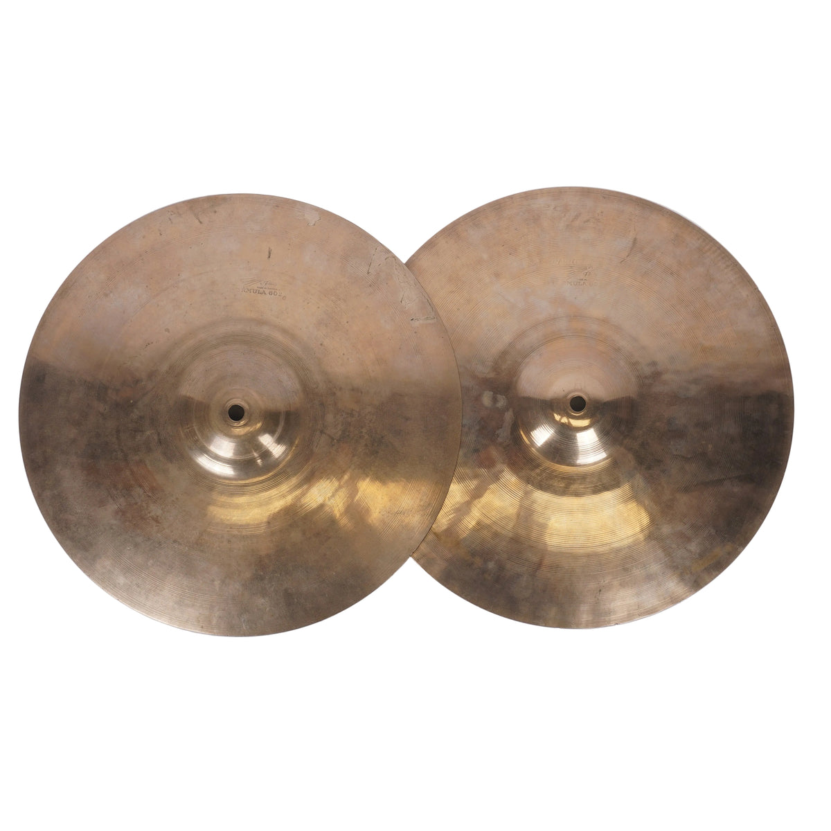 Two round brass cymbals with a warm gold and bronze metallic finish, photographed from above on a plain off-white background.