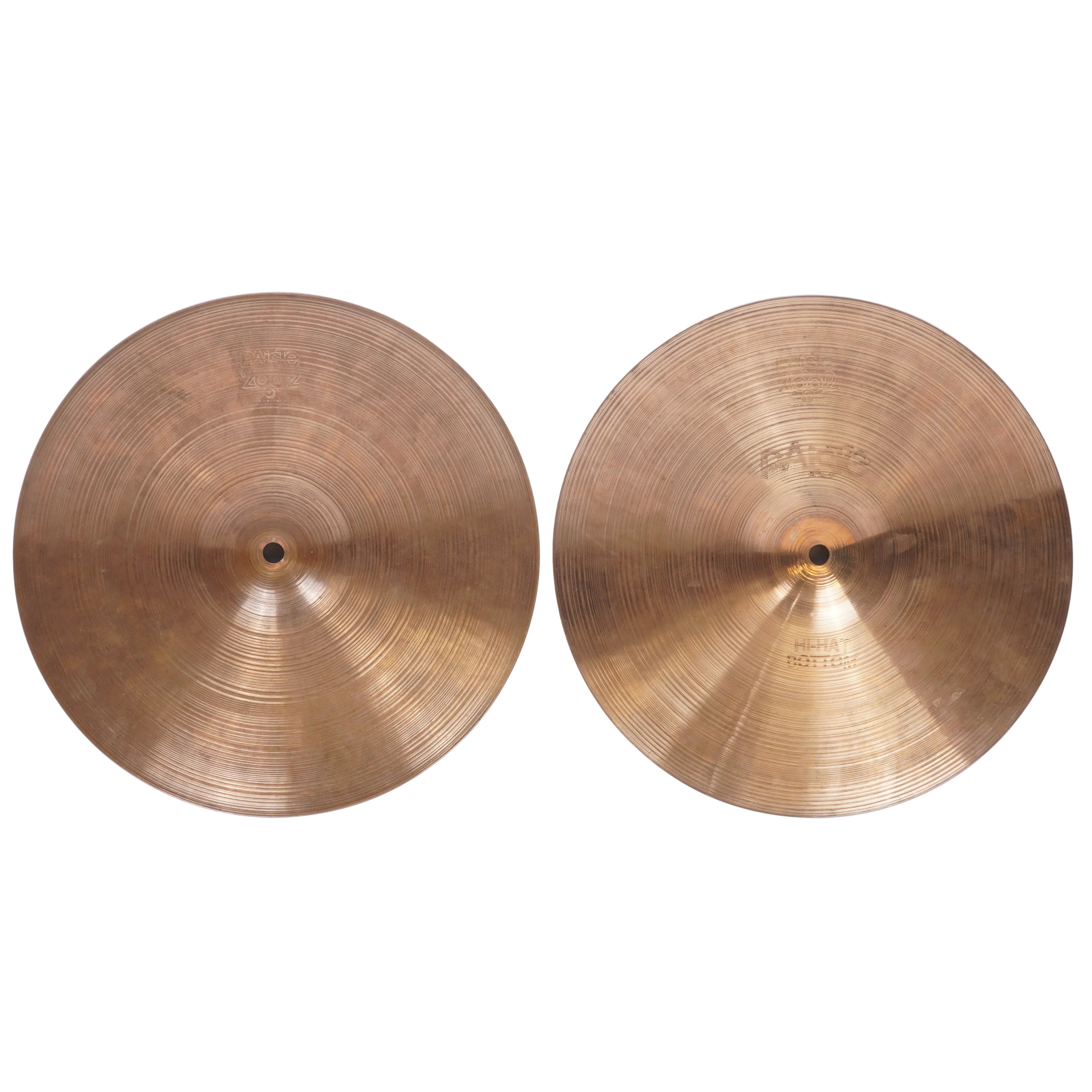 Two brass cymbals, one showing the raised center and one showing the branded side with 'MAGNEZ' and 'HARD ROUGH' text, displayed side-by-side on a light gray background.