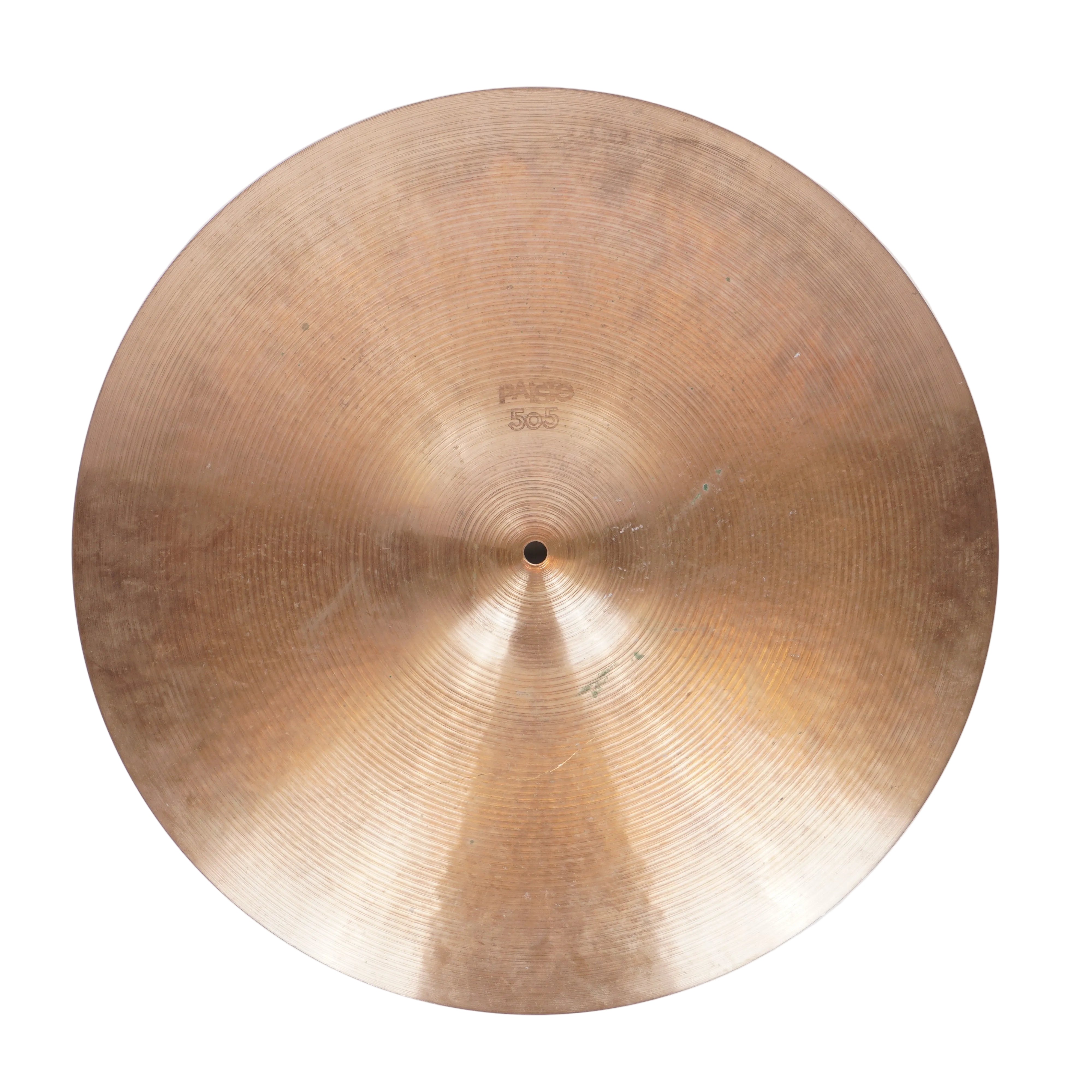 A single round brass or bronze cymbal photographed from above on a plain light background.