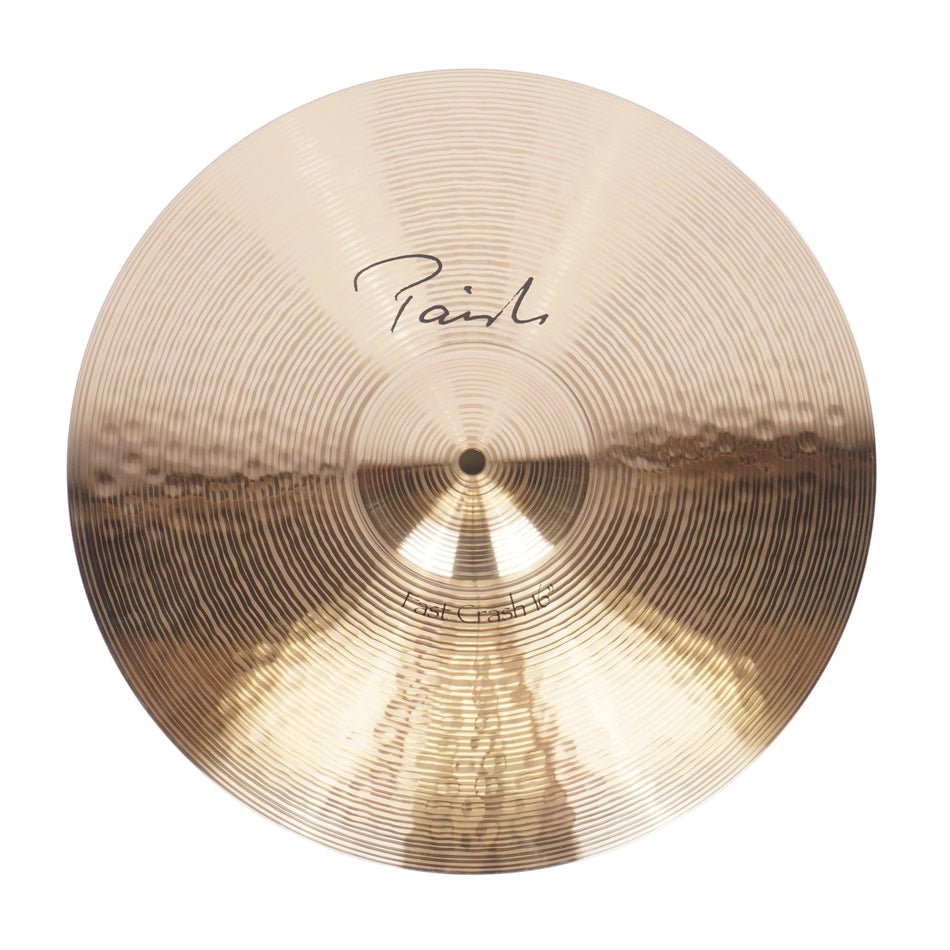 A single gold-toned metal cymbal photographed from above on a plain white background. The cymbal has a reflective metallic finish with concentric ring texture and a black script signature near the upper center.