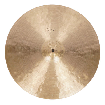 A single Pauwels cymbal with a warm gold-bronze metallic finish, photographed from directly above on a light off-white background.