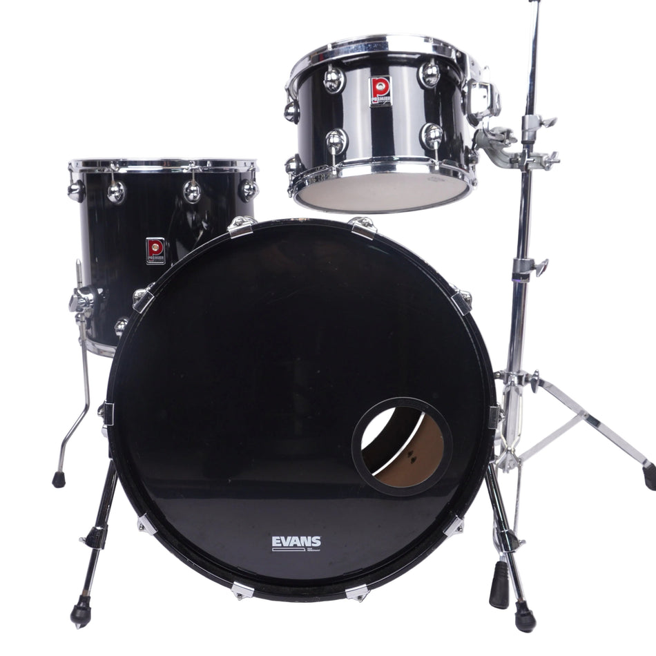 A black Evans drum kit with chrome hardware, including a bass drum, tom, and stand, photographed against a plain white studio background.